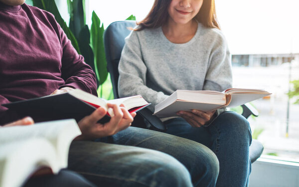 Group of young people sitting and enjoyed reading books together