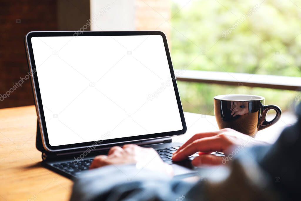Mockup image of a woman using and typing on digital tablet keyboard with blank white desktop screen as a computer pc