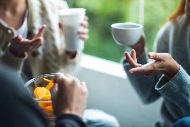 Arkadaşların birlikte patates cipsi yiyip içerken çekilmiş yakın plan görüntüleri.