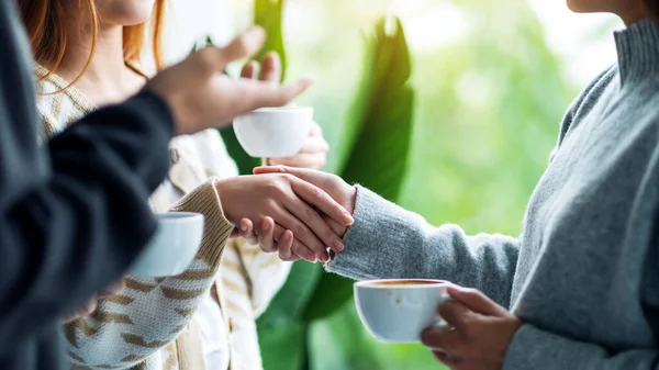 Closeup Image Two People Holding Hands While Drinking Coffee Together — Photo