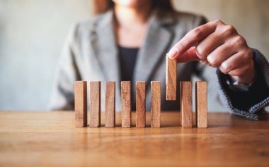 İş adamının yakın plan görüntüsü iş konsepti için tahta bloğu masaya koyuyor.