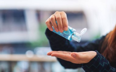 Closeup image of a woman applying alcohol gel to clean hands for Healthcare and Covid-19 or 2020 virus concept