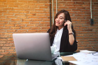 Closeup image of a beautiful asian businesswoman using and typing on laptop while working in office