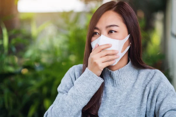 Sağlık ve Covid-19 veya 2020 virüs konsepti için koruyucu yüz maskesi takan Asyalı bir kadının yakın plan görüntüsü