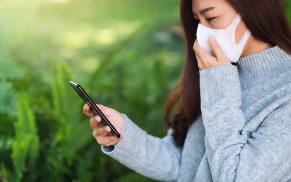 Closeup Image Sick Woman Wearing Protective Face Mask Using Mobile — Photo