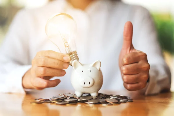 Woman Making Showing Thumbs Hand Sign While Putting Light Bulb — Fotografia de Stock