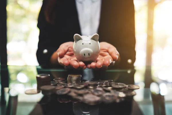 Closeup Image Businesswoman Holding Piggy Bank Pile Coins Table Saving — Fotografia de Stock