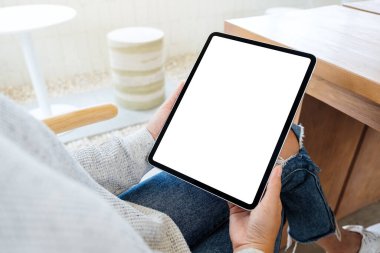 Boş beyaz masaüstü ekranlı siyah tablet bilgisayar tutan bir kadının görüntüsü