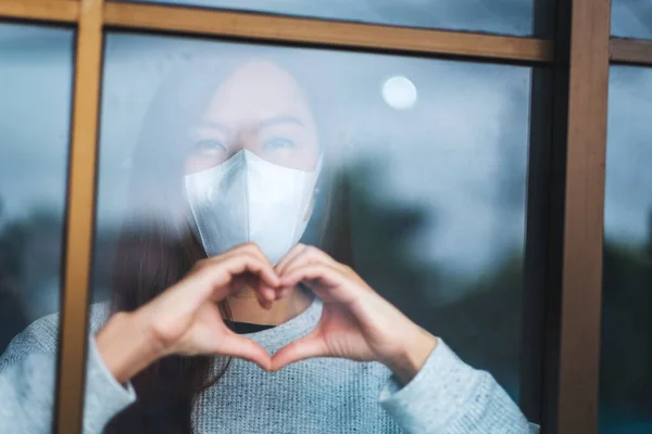 Young Asian Woman Wearing Protective Mask Doing Heart Hand Sign Stok Resim