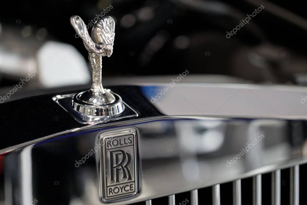 Poland, Poznan - April 08, 2022: Closeup sign of Rolls Royce logo on car Hood ornament on a vintage Rolls Royce car. Rolls-Royce is a British luxury car.