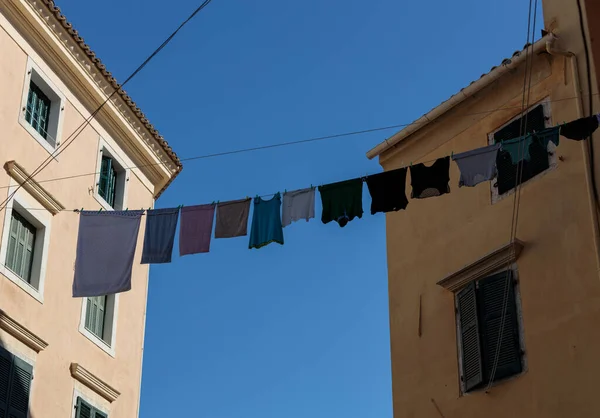 Laundry on a line, strung between buddings. The historic part of Corfu town.