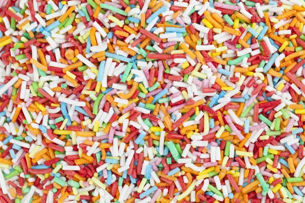 Bunte Bonbons bestreut Hintergrund — Stockfoto