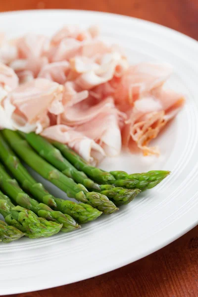 Asparagus and prosciutto — Stock Photo, Image