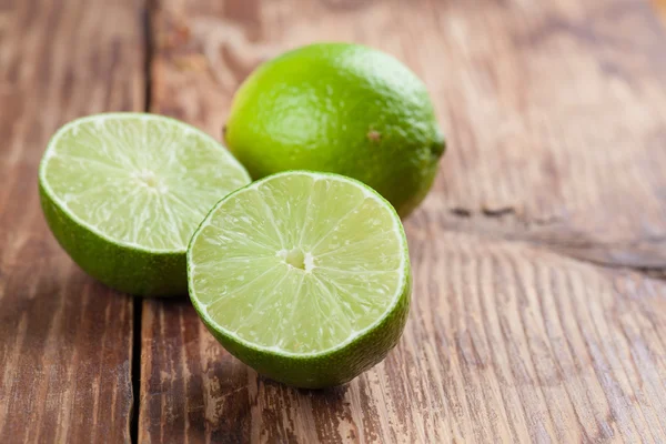 Limes on wooden background — Stock Photo, Image