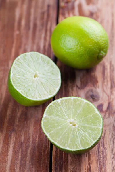 Limes on wooden background — Stock Photo, Image
