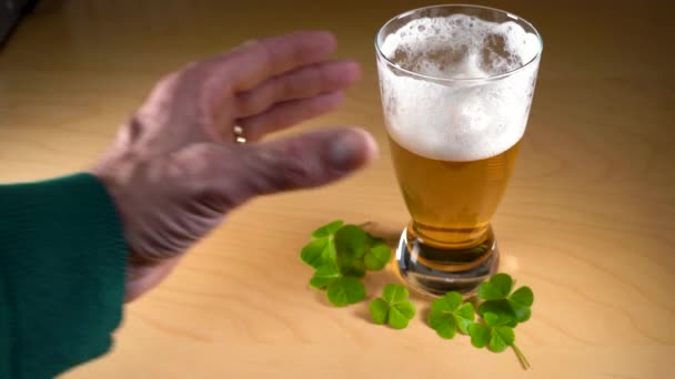 Hand grabbing and raising a glass of beer. St. Patricks day concept — стоковое видео
