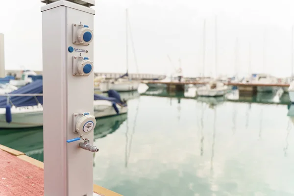 Supply post for water and electricity on a pier head for Yacht Marina — Stock Photo, Image