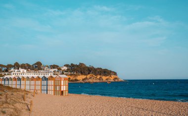Famous beach huts in Sagaro with Playa de Sant Pol, Costa Brava. Spain. Mediterranean Sea. The bathing huts date from the early 1920s clipart