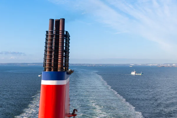 Chimney at a ship sailing a a blue sea — Stock Photo, Image