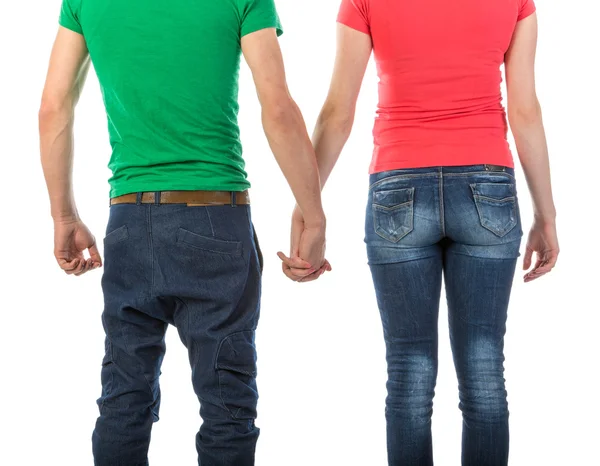 Young couple seen from behind holding hands on white Background — Stock Photo, Image