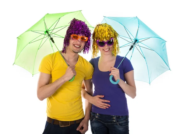 Couple with wigs, sunglasses and umbrellas — Stock Photo, Image