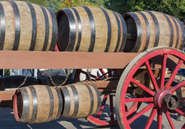 Wooden barrels at an old farm wagon in a countryside parade clipart