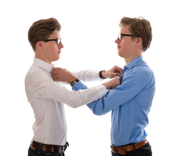 Male twins correcting each other clothes — Stock Photo, Image