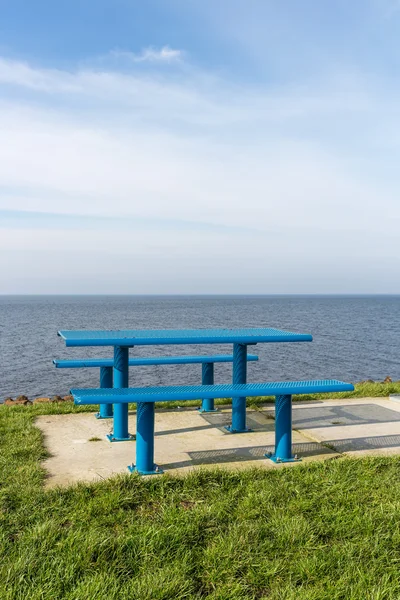 Steel picnic table at Dutch coast with room for copy space — Stock Photo, Image