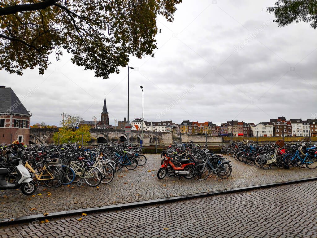 Lots of bicycles at the Maas promenade in Maastricht, Netherlands parked in Het Bat in front of the Cafe t Pothuiske