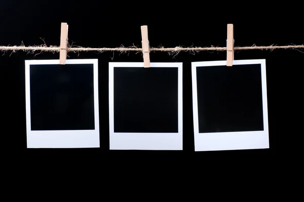 Blank photo frames on line on black — Stock Photo, Image