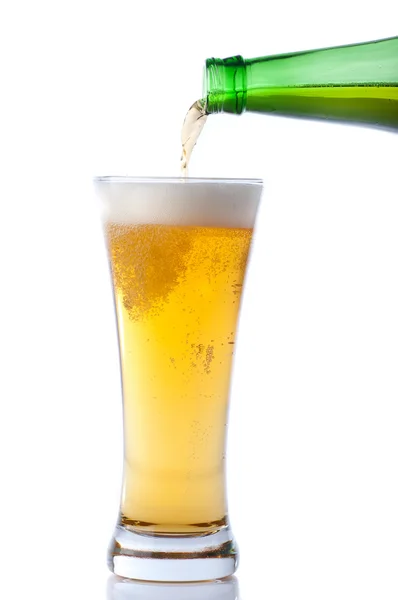 Beer pouring from bottle into glass on white — Stock Photo, Image