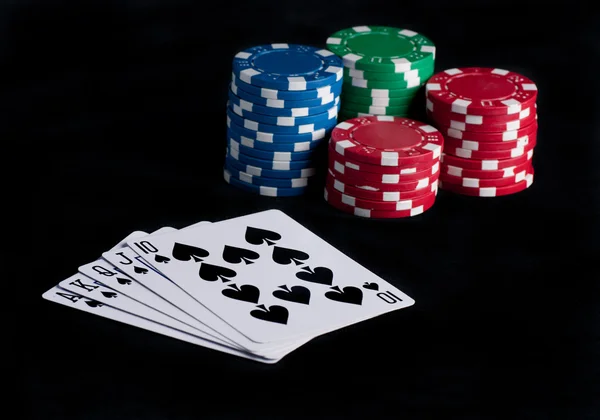 Flash royal on black table with chips — Stock Photo, Image