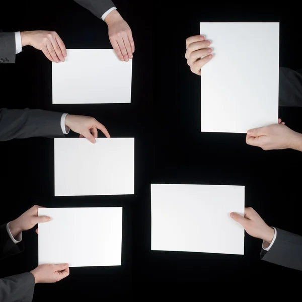 Collection of hand holding blank paper on black — Stock Photo, Image