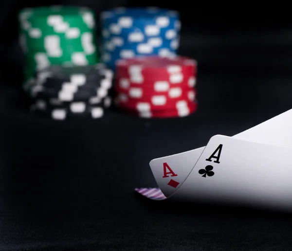 Two aces high on black table with chips — Stock Photo, Image