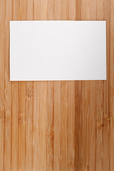 Blank business (visit) card on old wooden table