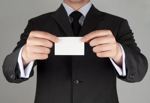 Business man handing a blank business card — Stock Photo, Image