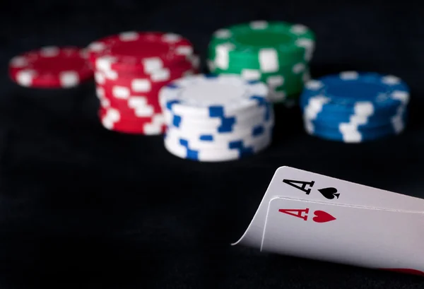 Two aces high on black table with chips — Stock Photo, Image