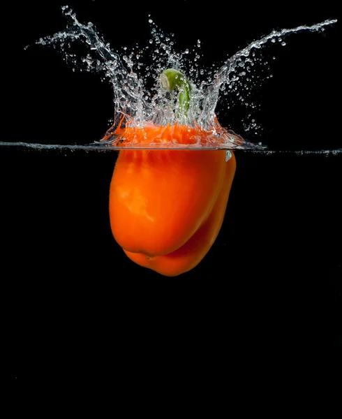 Fresh pepper splash in water on black background Royalty Free Stock Images