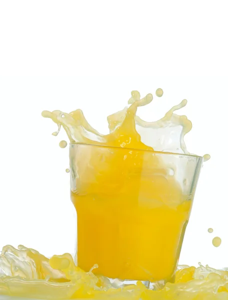 Glass of splashing orange juice — Stock Photo, Image