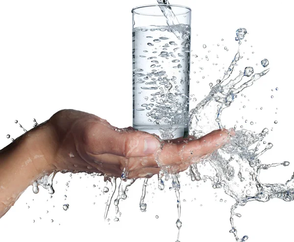 Human hands with glass and water splashing on them — Stock Photo, Image