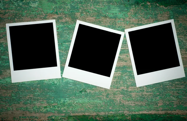 Vintage blank photo on wooden table — Stock Photo, Image