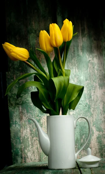 Yellow tulips over green wooden background — Stock Photo, Image