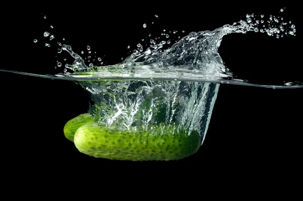 Cucumber splashing in water — Stok Foto