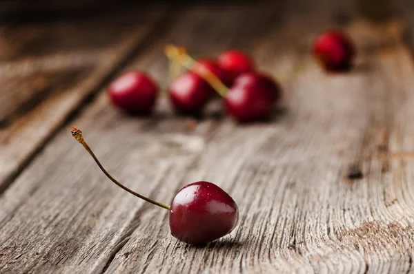 Cerezas sobre mesa de madera con gotas de agua macro fondo —  Fotos de Stock