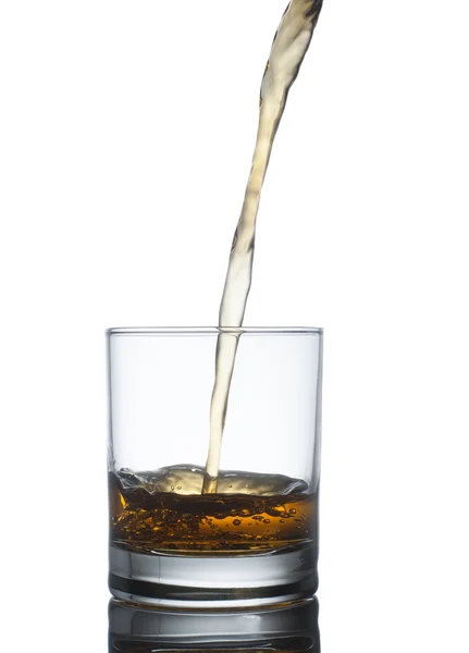 Scotch whiskey splashing out of glass. Isolated on white  backgr — Stock Photo, Image