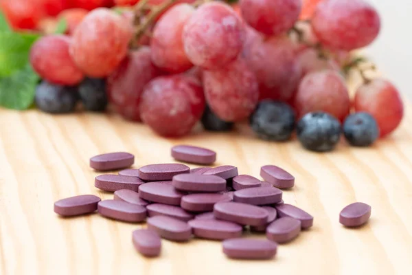 Purple Vitamins Supplements Wooden Table Variety Fruit — Stok fotoğraf