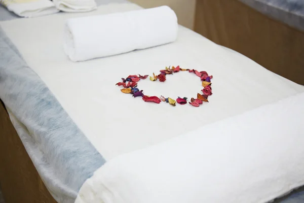 Romantic massage bed with petals — Stock Photo, Image