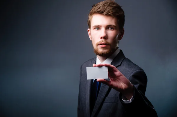 Business man handing a blank business card — Stock Photo, Image