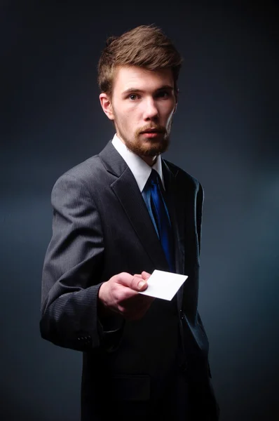 Business man handing a blank business card — Stock Photo, Image