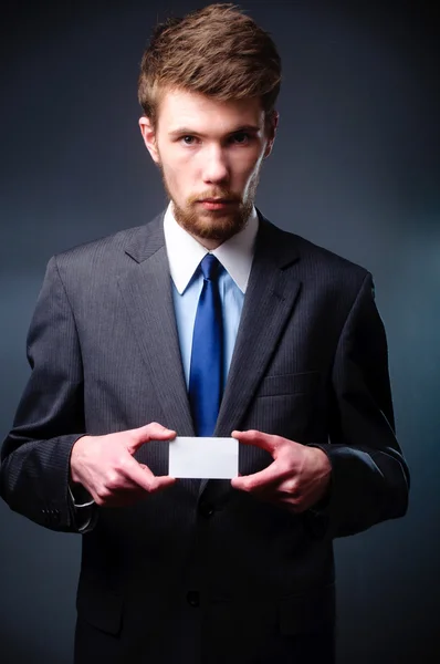 Business man handing a blank business card — Stock Photo, Image